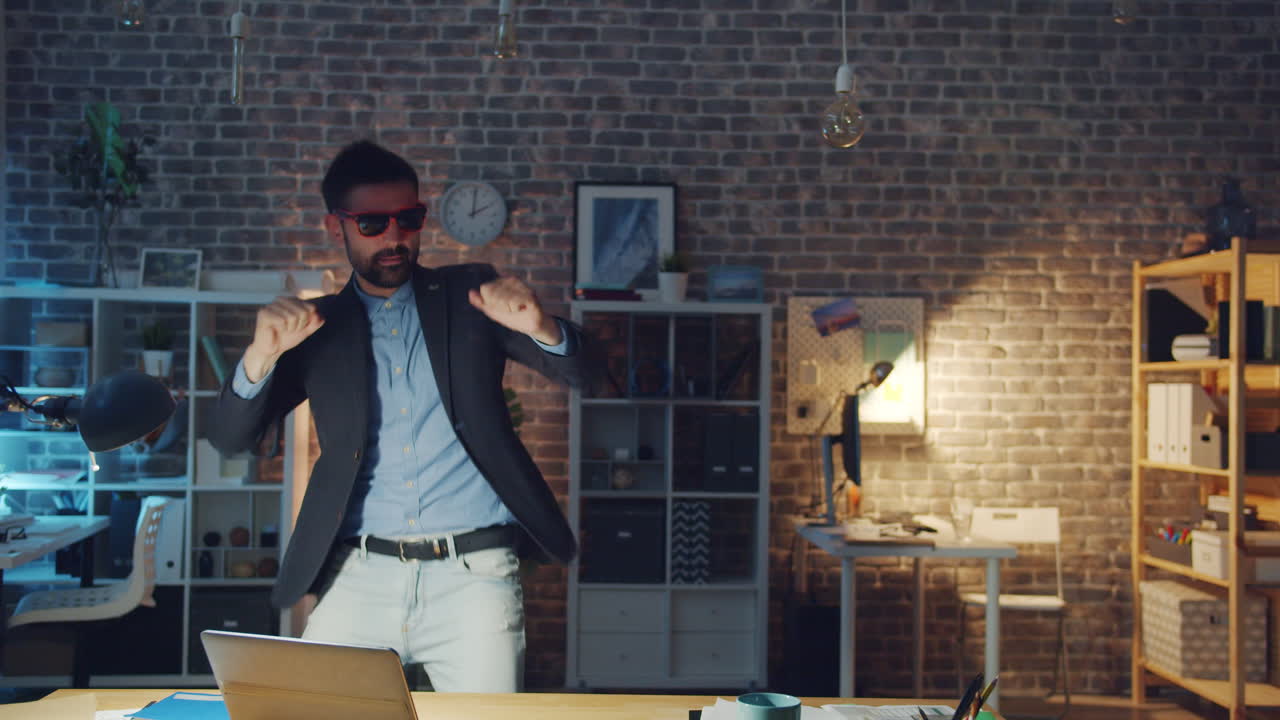 Man Dancing in Office at Night