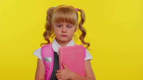 funny smiling schoolgirl making humorous face with eyes crossed, playing fool, having fun, brainless