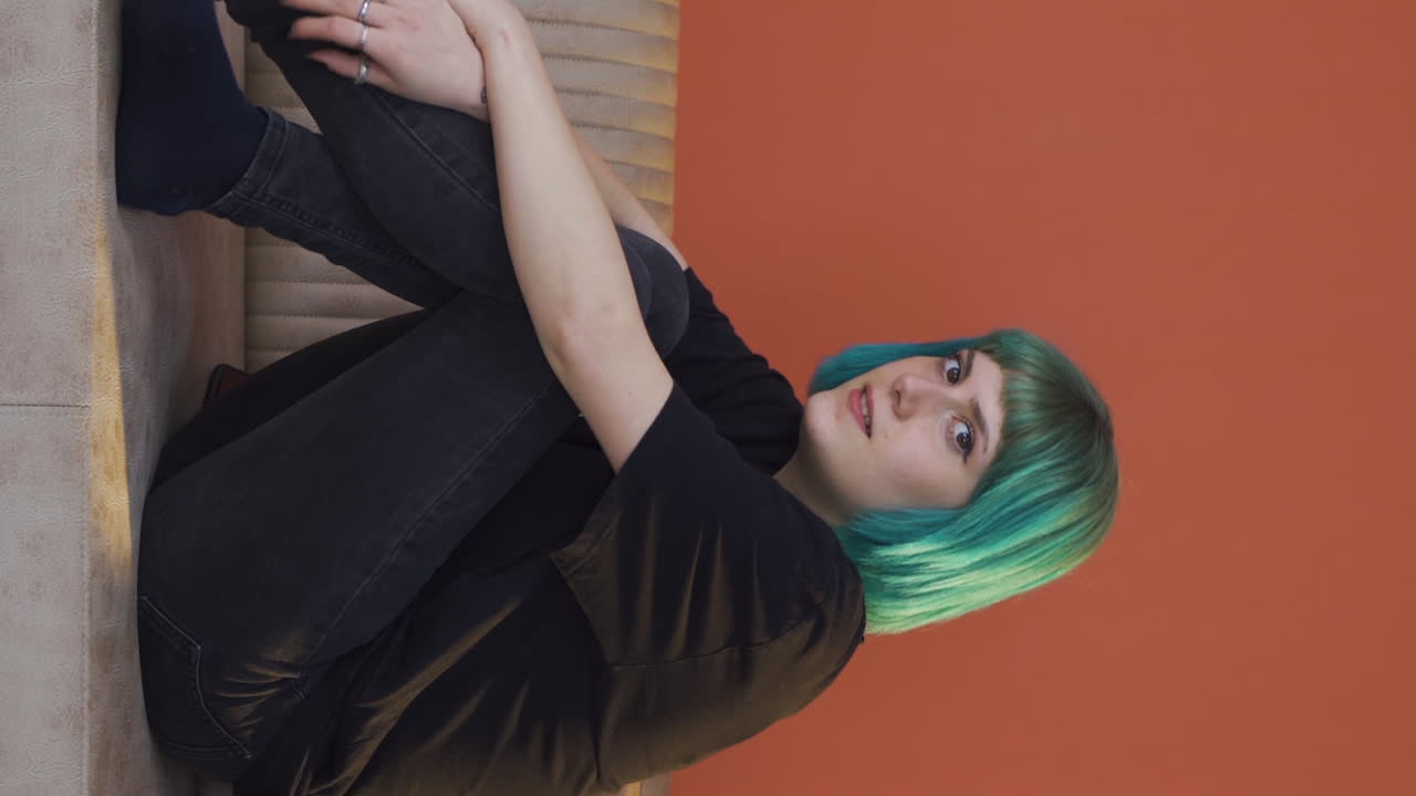 어려움으로 카메라를 바라보는 젊은 여성의 수직 비디오.