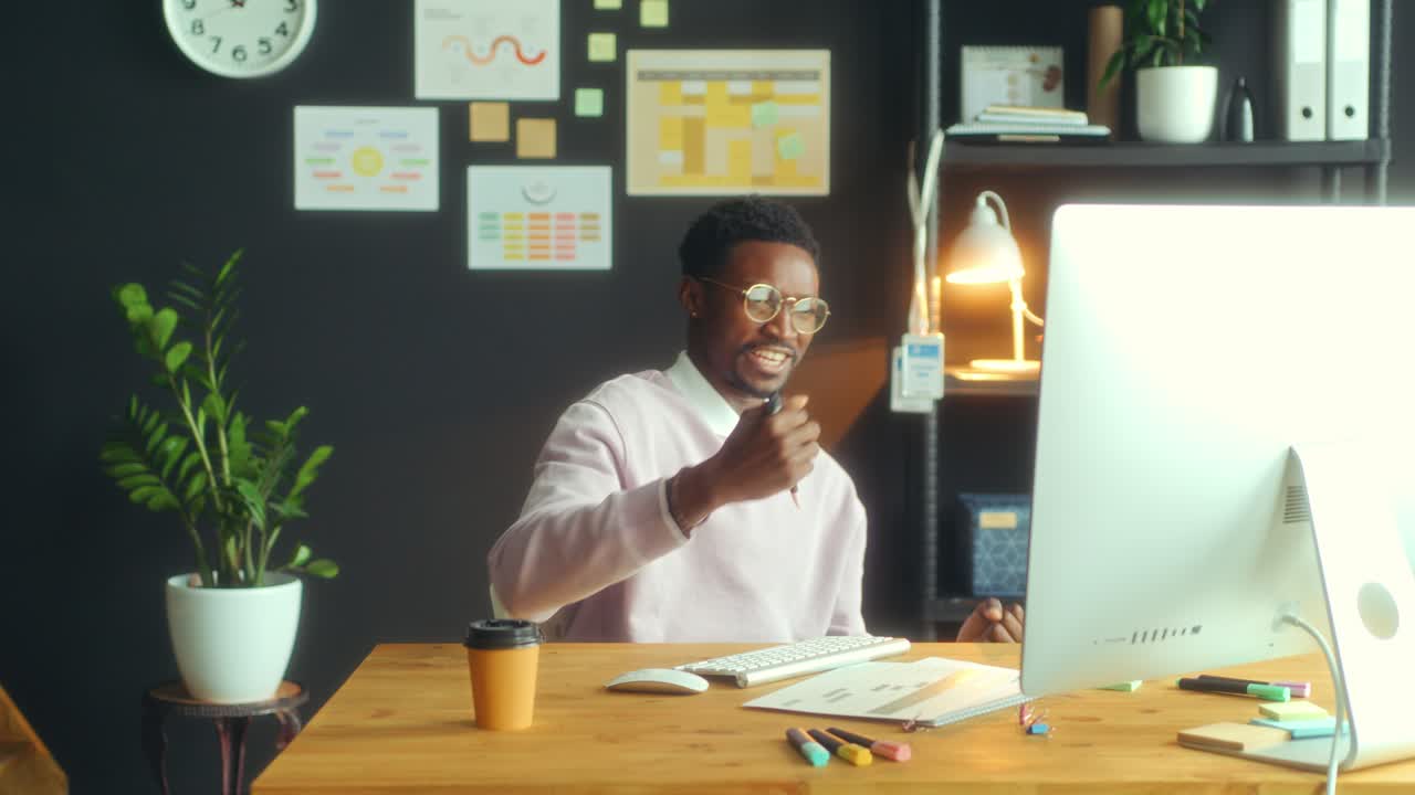Excited Black Businessman Celebrating Successful Project in Office
