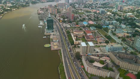 Traffic-and-cityscape-of-Falomo-Bridge,-Lagos-Law-school-and-the-Civic-centre-tower-in-Lagos-Nigeria