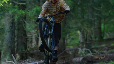 a mountain biker rides on his rear wheel only