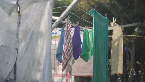 clothes hanging on an outdoor drying rack during the daytime