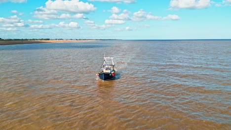 fishing boat just offshore fishing trawling with the