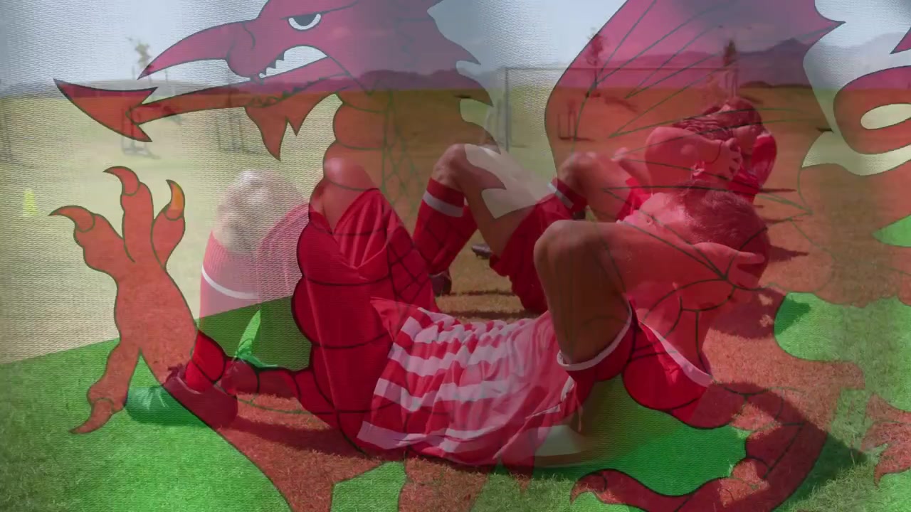 Soccer players starting drill doing crunches on turf for core fitness while dragon emblem hovering