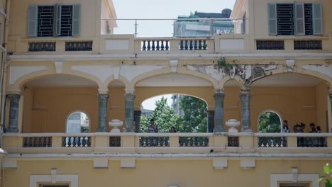 vintage building exterior with people on balconies