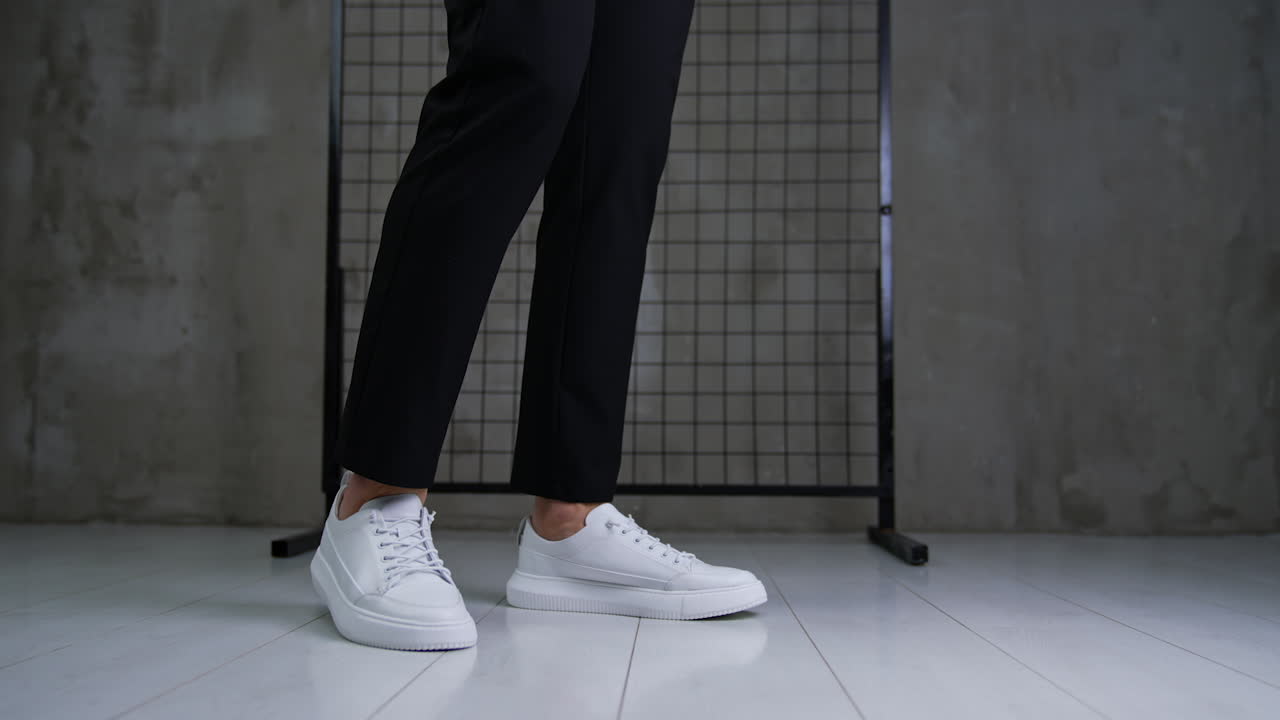 Stylish white sneakers with black pants