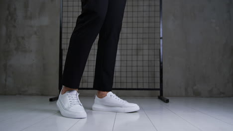 Stylish white sneakers with black pants