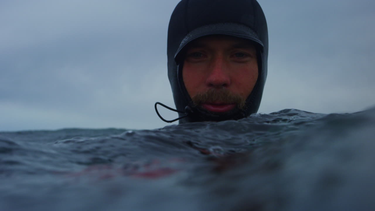Water level of photographer paddling and positioning for incoming Atlantic swell, slow motion waiting at surface