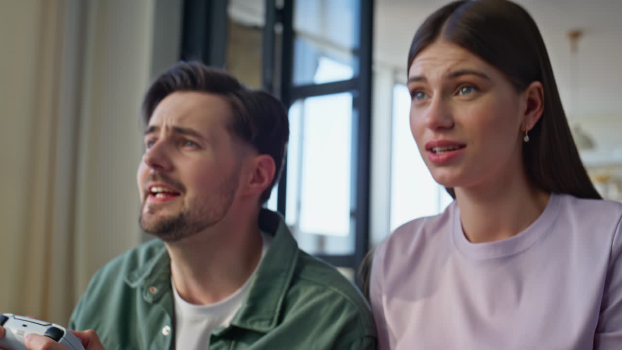 Hands video players holding consoles enjoying game at home closeup. Two gamers