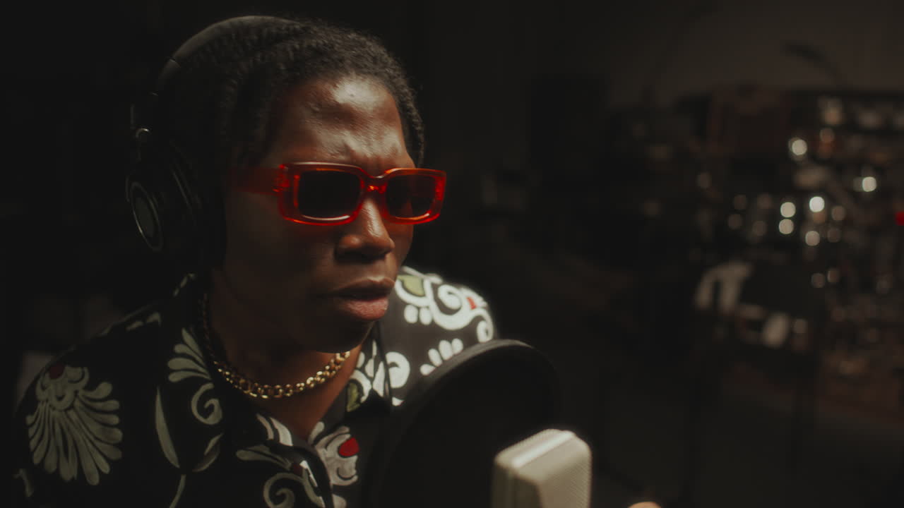 Stylish Black Singer in Headphones Performing in Music Recording Studio