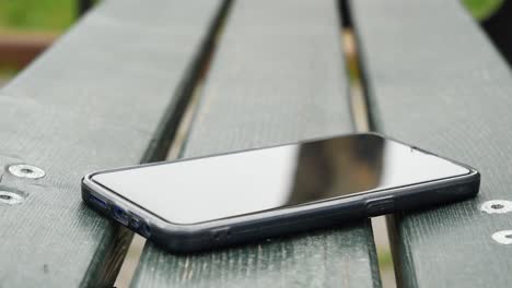 smartphone on a park bench