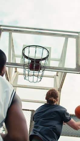 basketball players shooting at the hoop