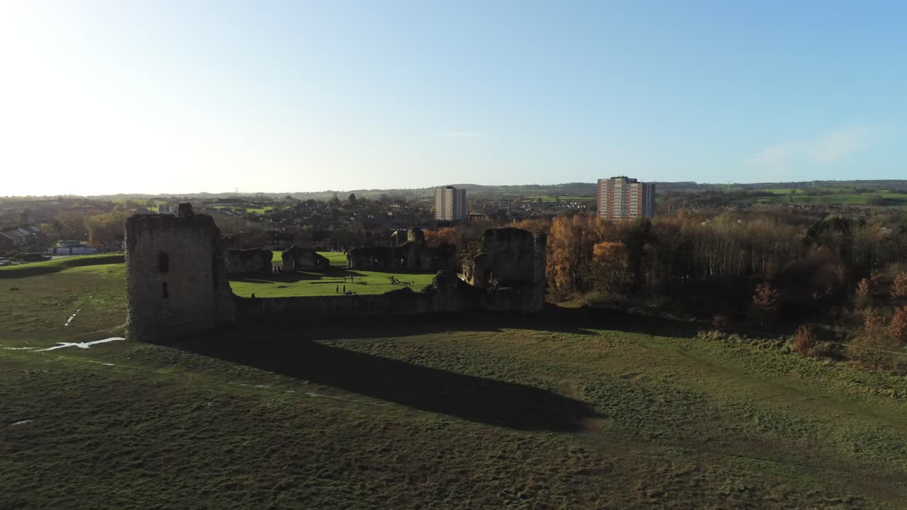 Ancient Flint castle medieval heritage military Welsh ruins aerial view landmark rising with lens flares