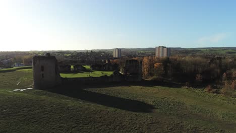 Ancient-Flint-castle-medieval-heritage-military-Welsh-ruins-aerial-view-landmark-rising-with-lens-flares