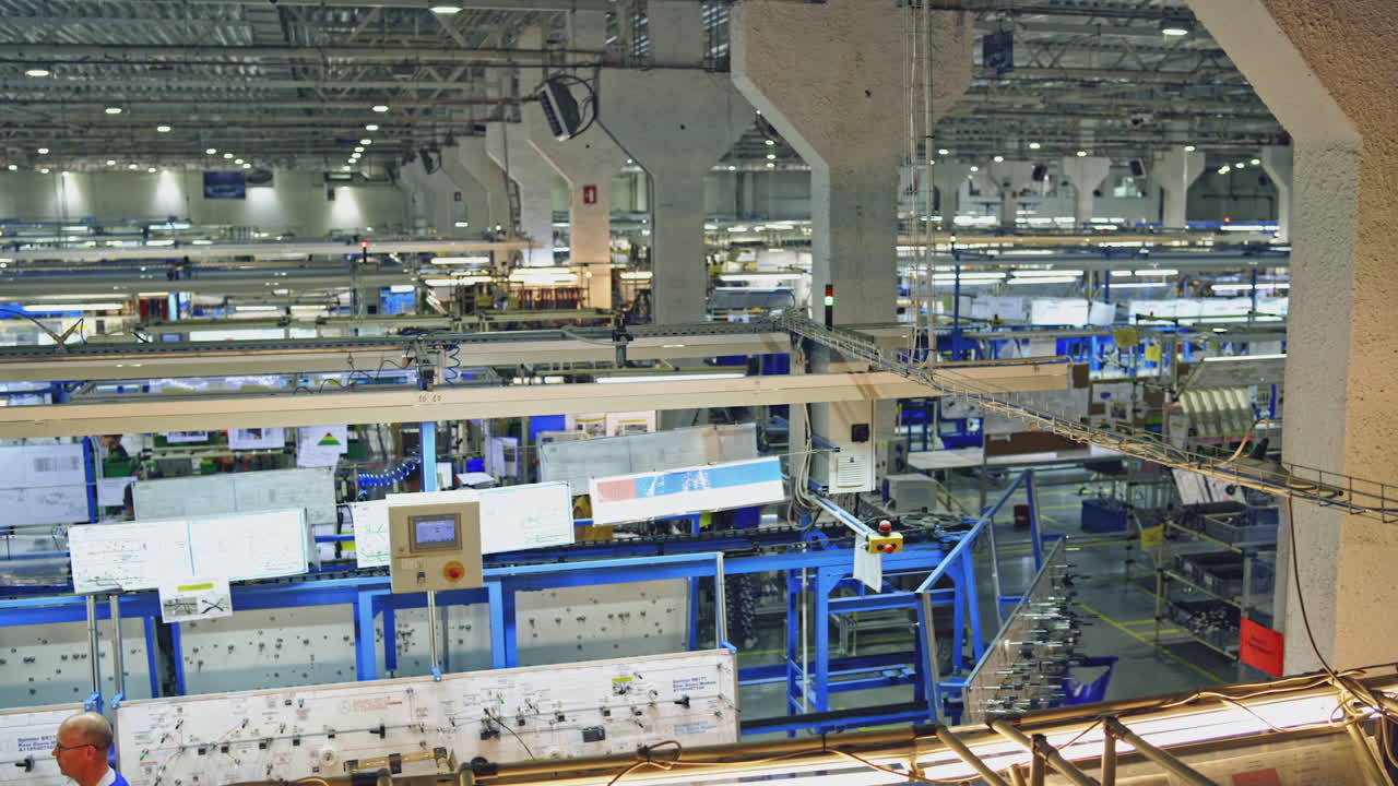 View inside of wire factory. Factory workers working inside factory