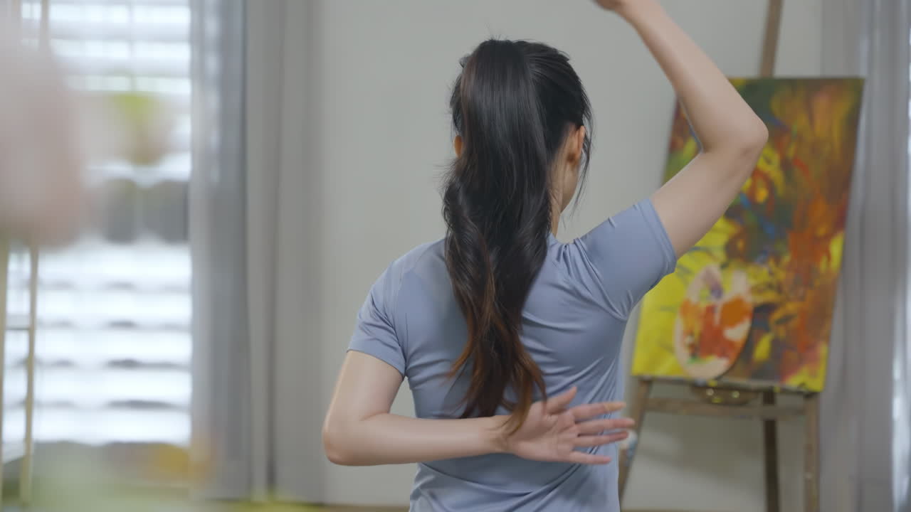 Jovem mulher calma e espiritual sentada em tapete de ioga em posição de lótus, praticando meditação de respiração iogue, fazendo o gesto namaste e mantendo as mãos em mudra enquanto pratica exercícios de fitness