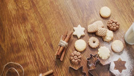 Video-of-christmas-decorations-with-cookies-and-copy-space-on-wooden-background