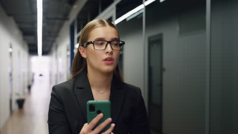 Portrait-office-manager-talking-on-virtual-conference.-Worried-woman-walking