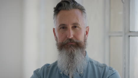 portrait of mature man looking at camera serious calm caucasian senior male with stylish beard real people series