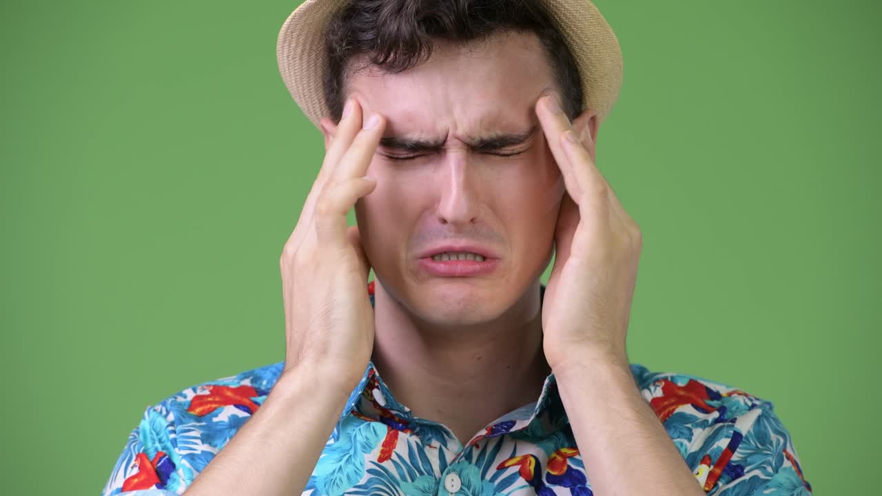Young handsome tourist man having headache