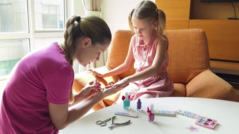 madre pintando las uñas de su hija