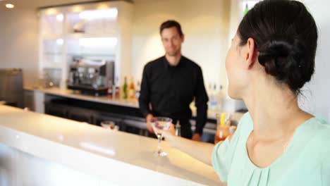 Asian-woman-ordering-a-cocktail-from-bartender