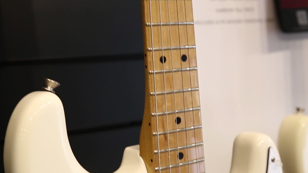 Professional white electric guitar, bottom-up movement