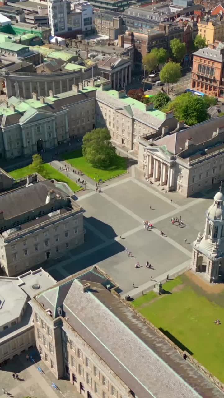 Side-on social ratio aerial video of the grounds of Trinity College Dublin in Dublin City Centre, Ireland on a bright and sunny day. Filmed in 1080x1920 and with Rec709 color