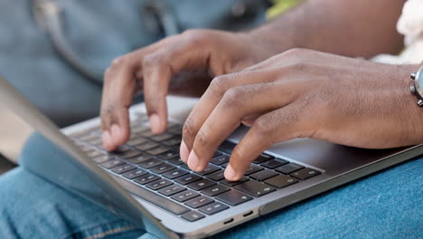 closeup of a man typing on a laptop keyboard