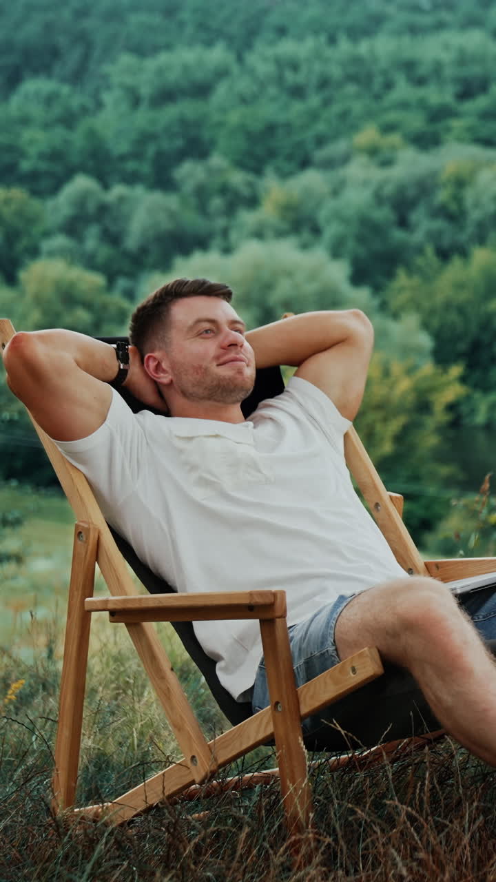 Man Relaxing in a Wooden Chair Outdoors
