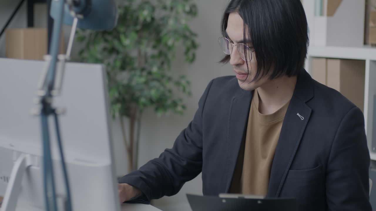 Businessperson working at a computer in an office