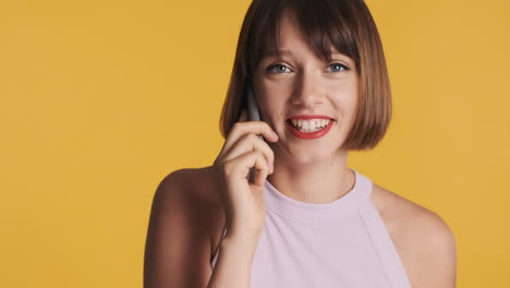 Brunette-woman-having-a-conversation-via-phone