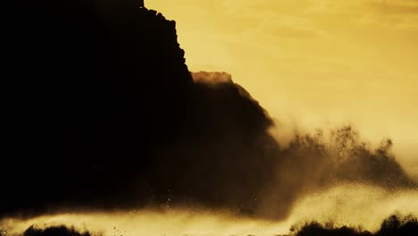 large waves roll into the coast of hawaii and crash into the shore in slow motion during a big storm 2