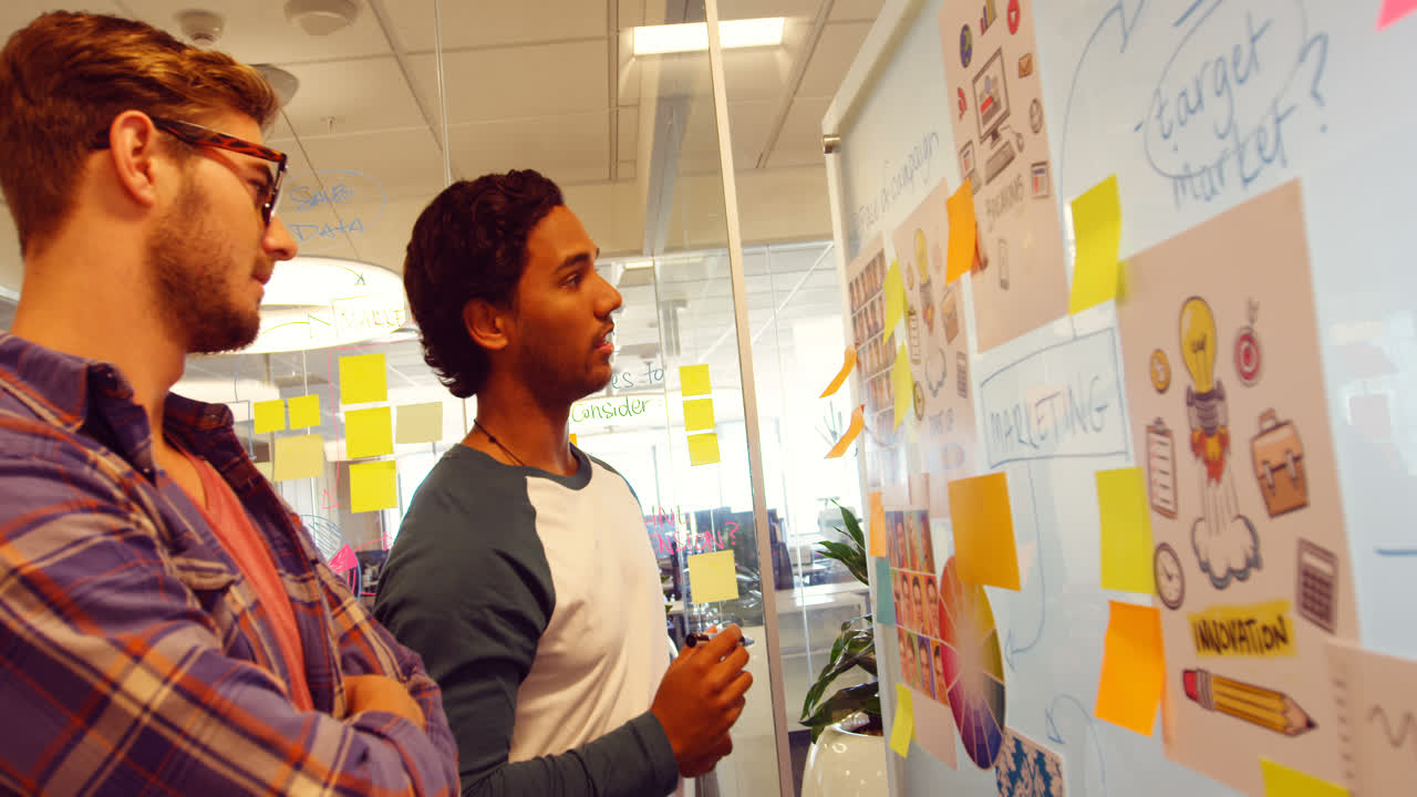 Business colleagues discussing over sticky notes