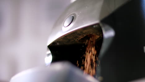 a coffee grinder grinds coffee in slowmotion