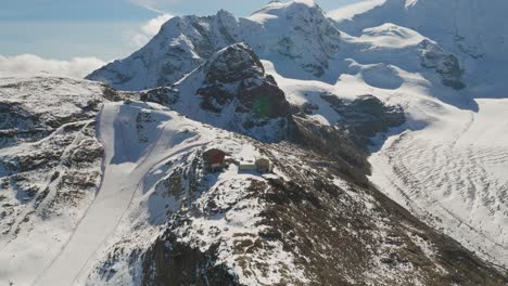 mountain gondola lift station at diavolezza glacier in alps, aerial