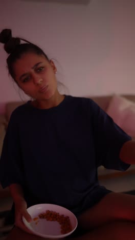 woman eating snacks at home