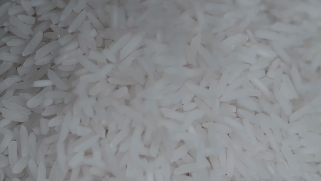 Close Up Of White Rice Falling On Over A Black Background Slow Motion ...