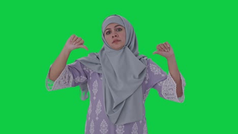 Disappointed-Muslim-woman-showing-thumbs-down-Green-screen