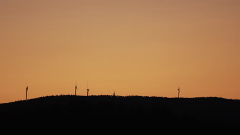 wind power generator turbines, at a sunny evening dusk, in hoga kusten, vasternorrland, sweden