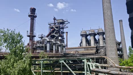 fascinating-shot-of-exciting-industrial-structures-with-pipes,-pillars,-buildings-and-metal-structures-over-the-landscape-parks-in-duisburg-north-in-germany