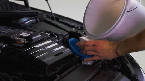 a man refilling his windscreen wiper fluid p2