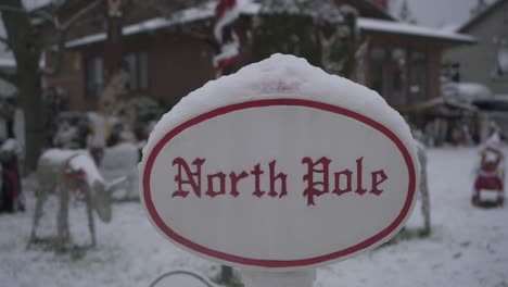 Close-up-footage-of-North-Pole-lawn-sign-during-Christmas-in-a-residential-neighborhood