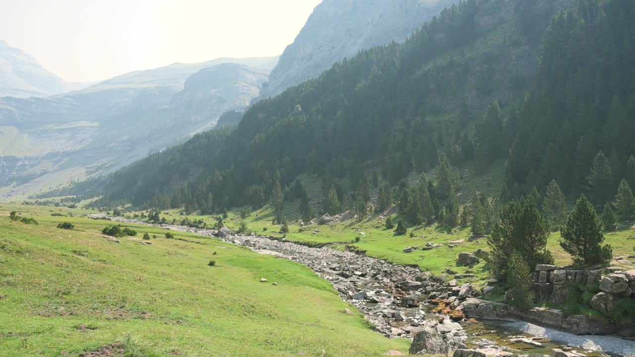 Breathtaking view of a river flowing through a green valley in the Pyrenees mountains