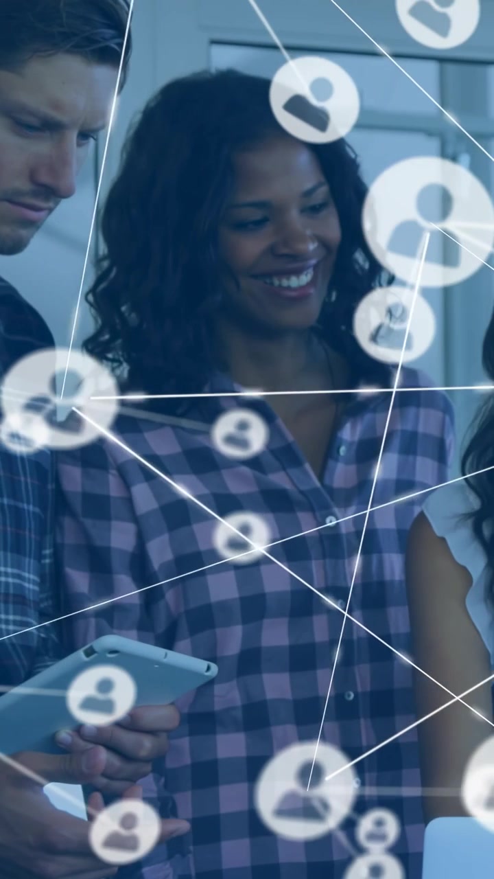 Vertical video: Network icons sliding across, driving IT team leaning over tablet and phone sharing