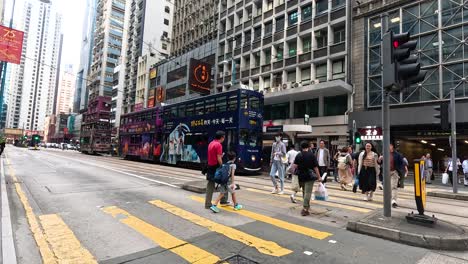 pedestrians crossing a bustling city intersection