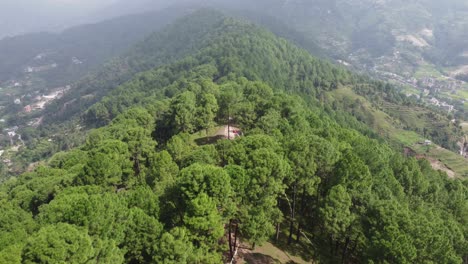 Aerial-view-of-flying-over-a-mountain-ridge-in-the-outskirts-of-Kathmandu,-Nepal