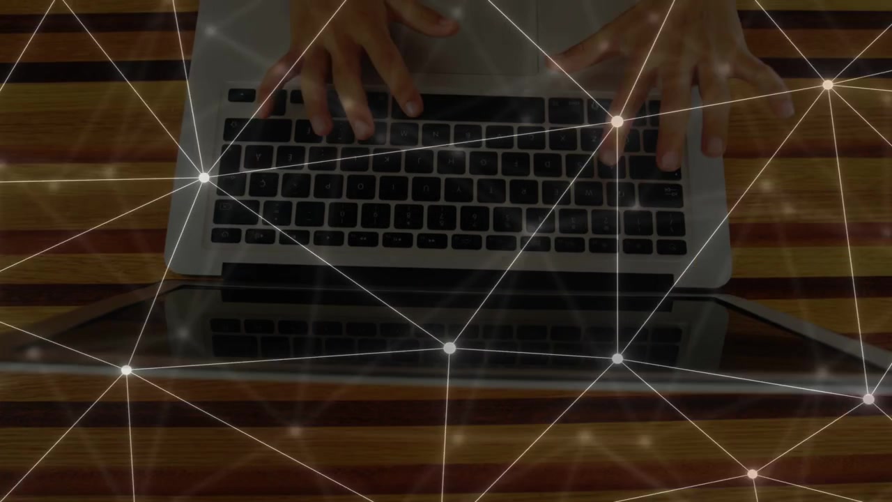 Hands entering frame, settling on laptop keys, typing rapidly to work while network overlay pulsing