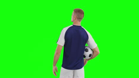 video of caucasian male soccer player with ball on green screen background